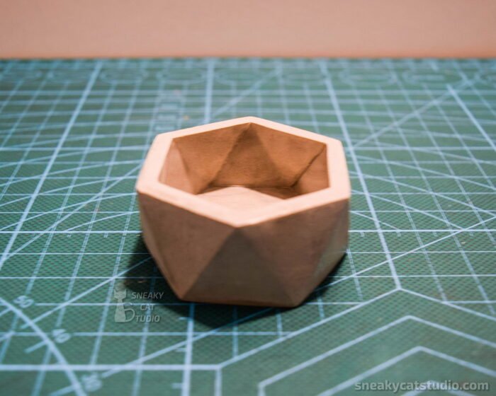 Concrete Geometric Candlestick on a green background front view