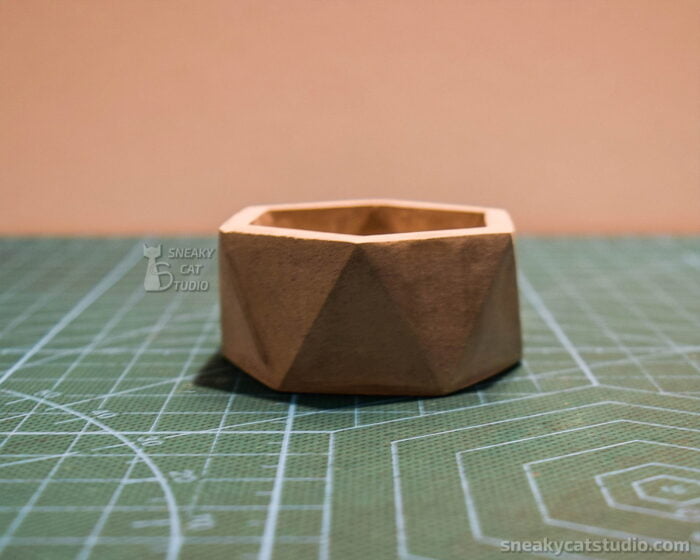 Concrete Geometric Candlestick on a green background side view