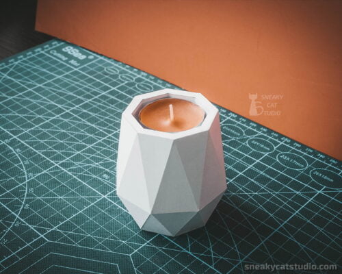 Paper Candlestick with candle inside on a green background front view
