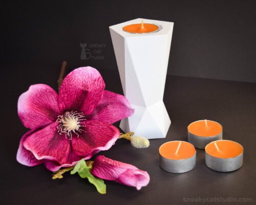 Geometric Candlestick with candles and magnolia on a dark background main view