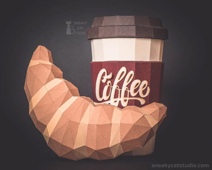 Polygonal Coffee cup and Croissant on a dark background main view