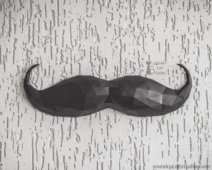 Paper Black Mustache on the gray wall front view