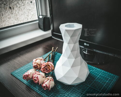 Geometric paper vase with flowers on a green background main view