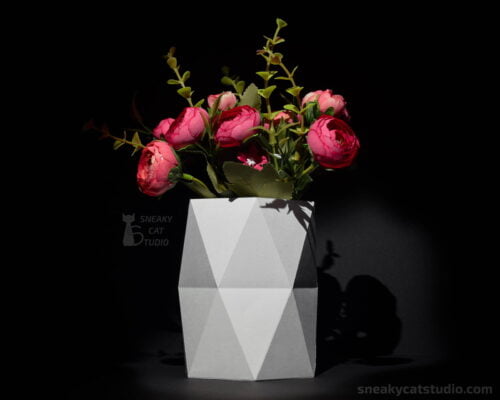 Geometric vase with flowers on a black background
