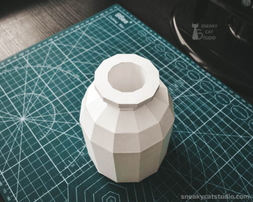 Geometric vase for interior on a green background front view