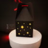 Paper black box with stars pattern on dark background side view
